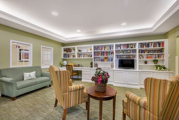 Cozy common area with comfortable seating and bookshelves