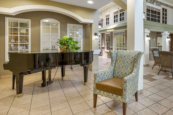 Interior lobby space with a piano and seating