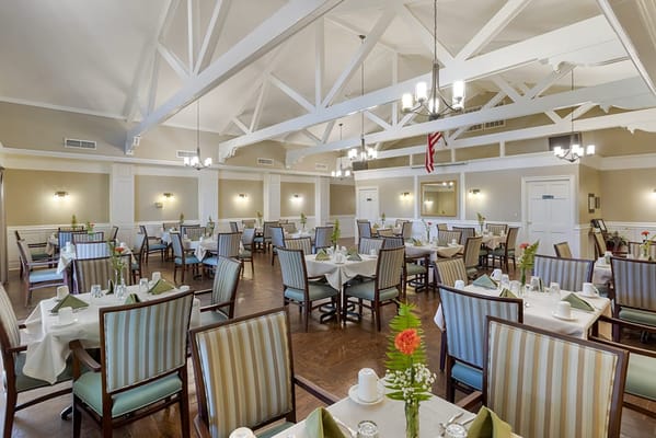 Dining room with tables set for meals and bright decor