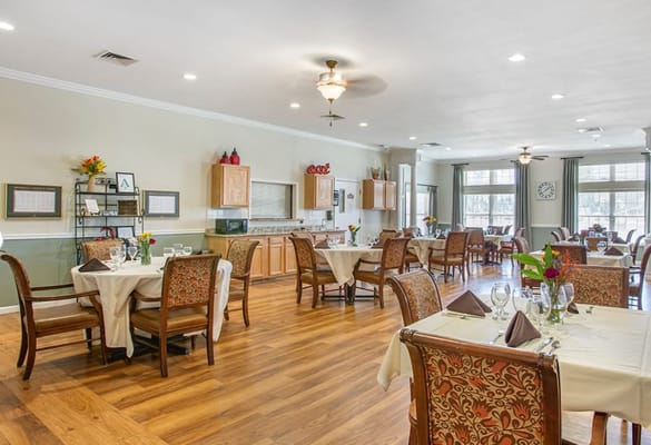 Bright dining room with tables set for a meal