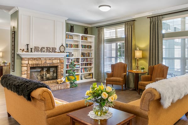 Cozy common area with chairs and bookshelves