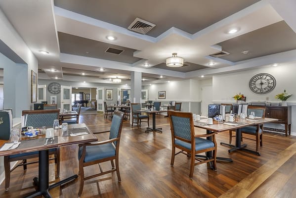 Dining room set up for residents with tables and chairs