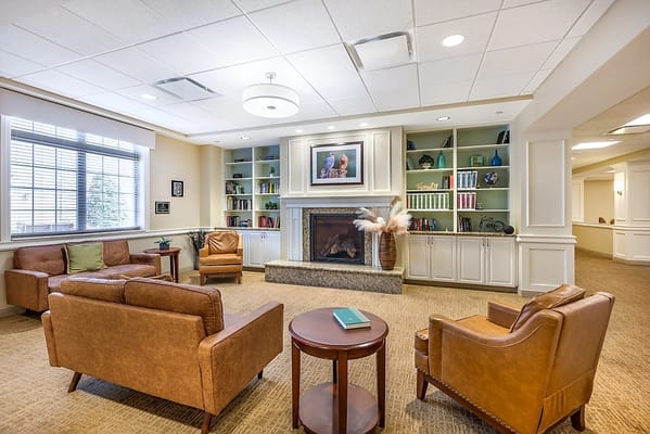 Cozy common area with seating and bookshelf