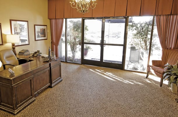 Interior view of a welcoming lobby area with desk and seating
