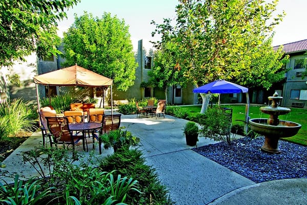 A serene outdoor space with seating and greenery