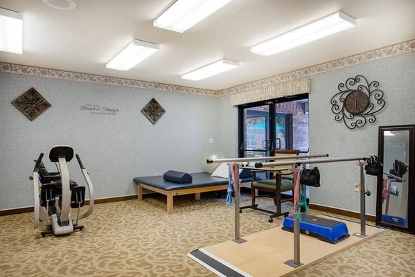 Rehabilitation gym with exercise equipment and therapy space