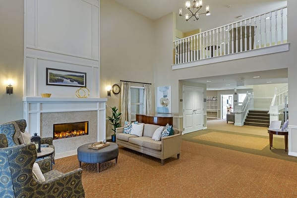 Bright and welcoming common area with seating and a fireplace