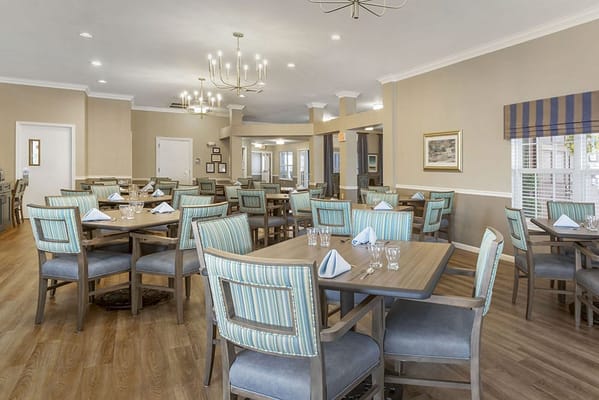 Dining room with elegantly set tables in a common area