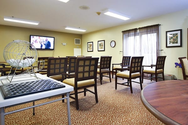 Interior of a common area with seating and a TV