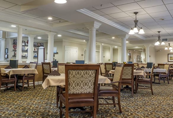 Dining area with elegantly set tables and chairs