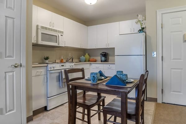Cozy kitchen area with dining table and appliances