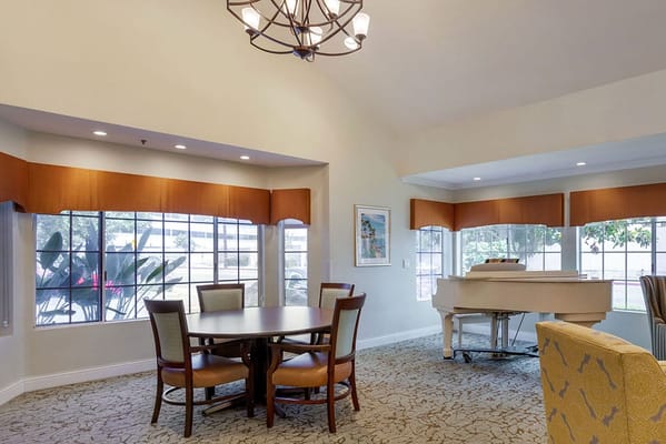 Bright common area with piano and seating
