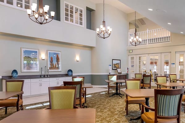 Bright and spacious common area with tables and chairs