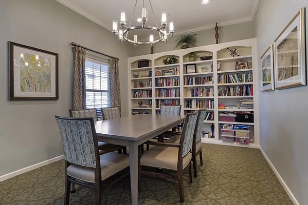 Dining area with a large table and shelves of books