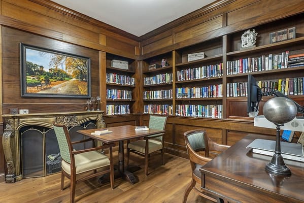 A cozy library with wooden shelves and books