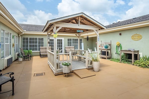 A cozy garden area with seating and a gazebo