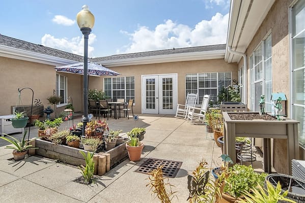 Bright outdoor patio with plants and seating