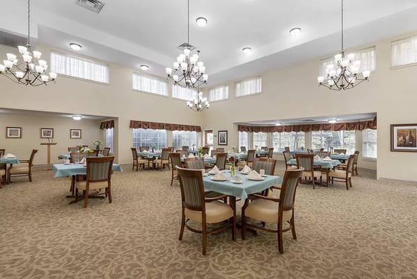 Bright dining room with tables set for meals