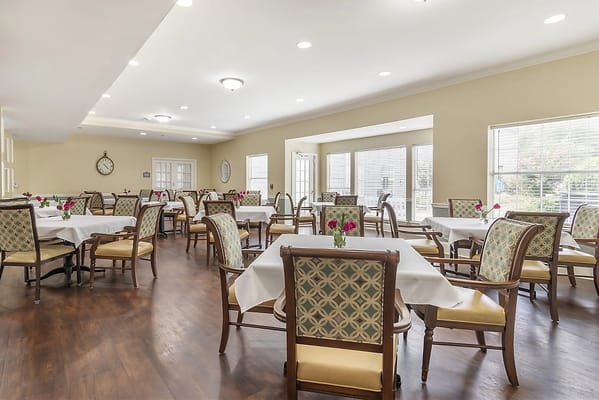 Bright dining room with tables and flowers