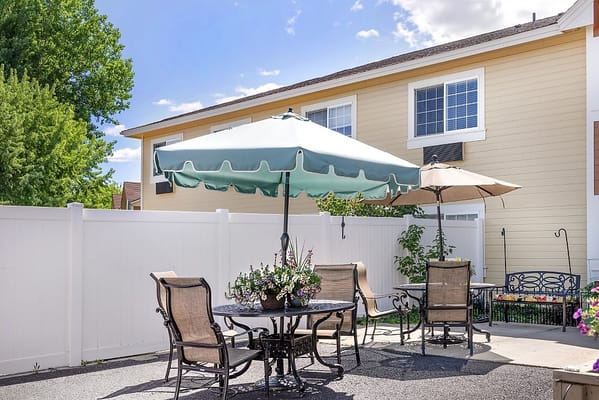 Outdoor seating area with umbrellas and flower arrangements