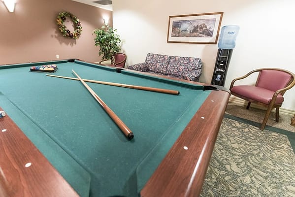 Billiard table in a common area with seating