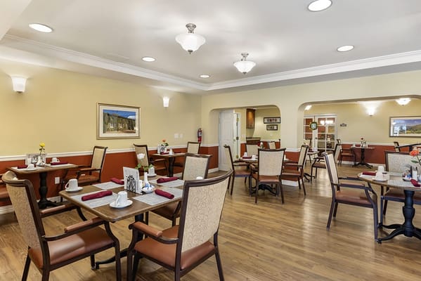 Dining area with tables and chairs set for mealtime