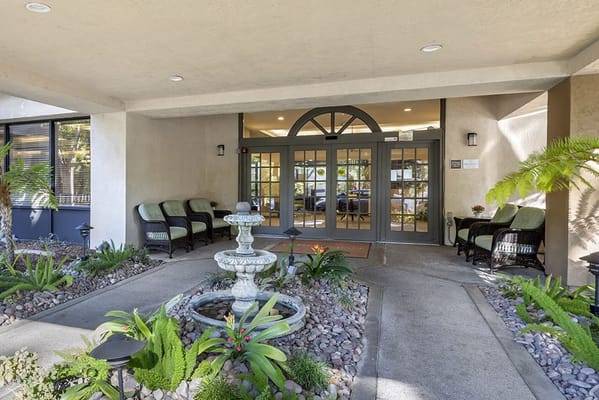 Entrance of Brookdale Nohl Ranch with seating and landscaping