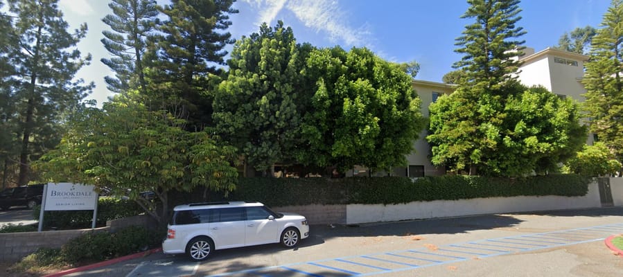 Exterior view of Brookdale Nohl Ranch with landscaping and vehicle