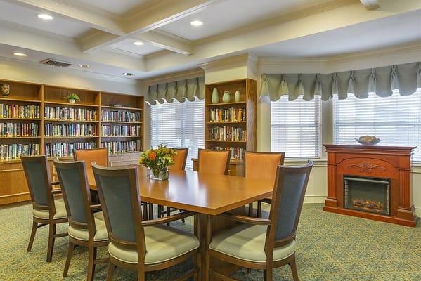 Bright common area with tables and bookshelves