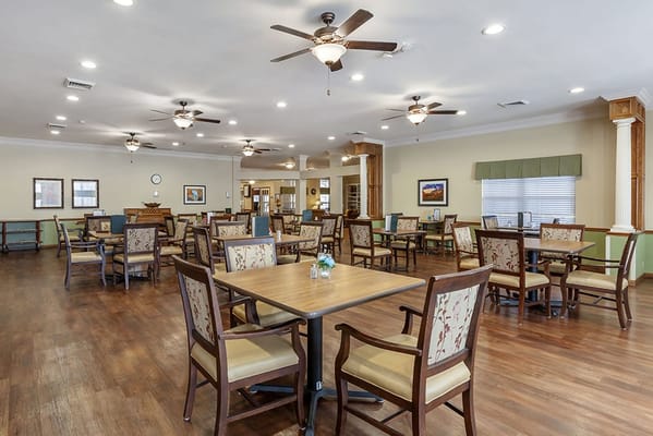 Bright dining room with tables and chairs for residents