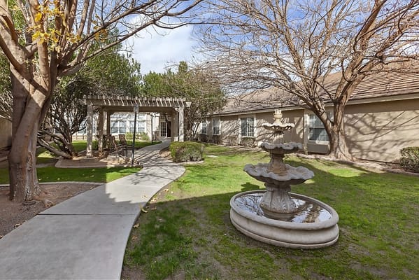 Beautiful garden area with a fountain and walking path