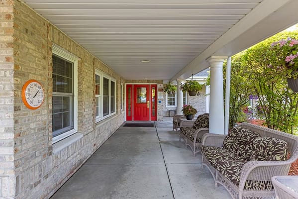 Covered porch area with seating and plants