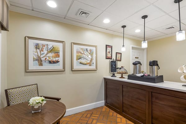 Interior view of a common area with art and coffee station