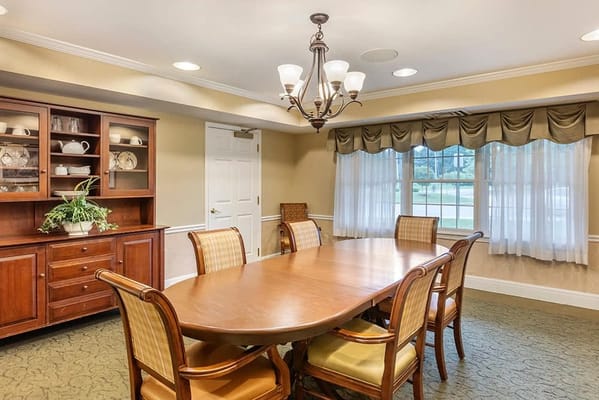 Cozy dining room with a large wooden table and chairs