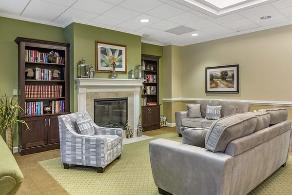 A cozy common area with comfortable seating and bookshelves