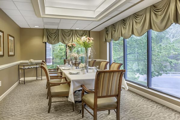 Dining room set up for a meal with flowers