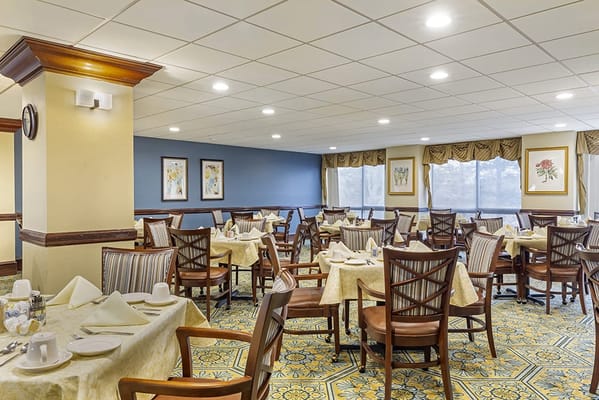 Interior view of a spacious dining room with tables and chairs