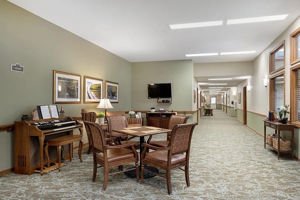 Bright common area with seating and piano