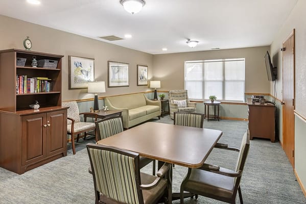 Cozy common area with seating and bookshelf