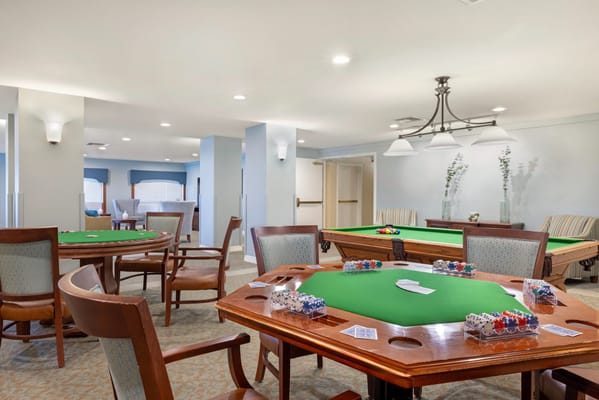Interior activity room with poker tables and chairs