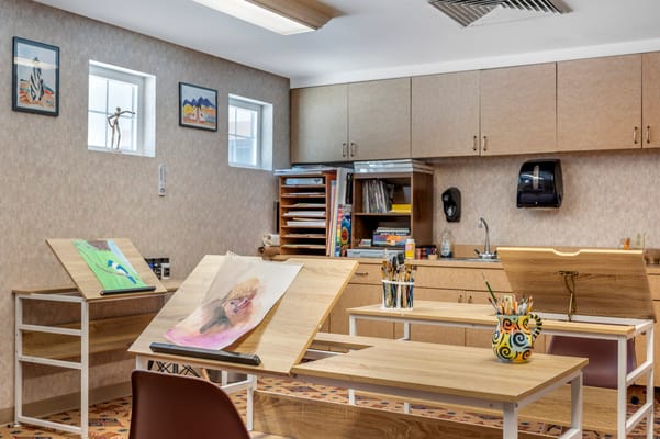 Art room with easels and supplies for resident activities