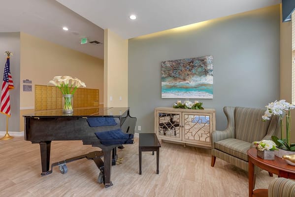 Common area with a piano and seating