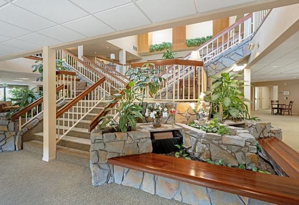 Bright interior lobby with plants and stone features