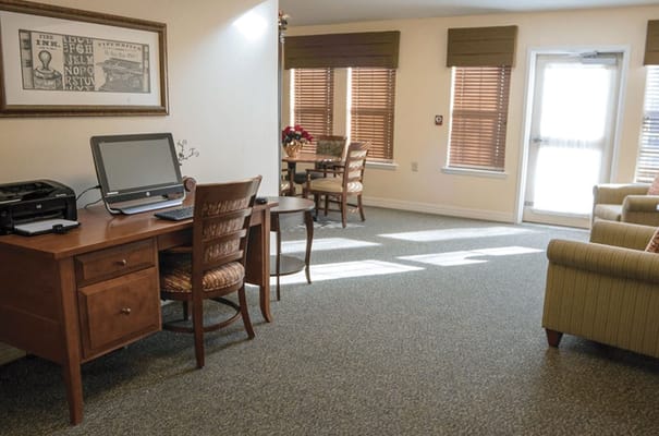 Bright common area with seating and a computer station