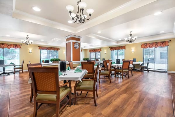 Dining room with tables and chairs in a bright setting