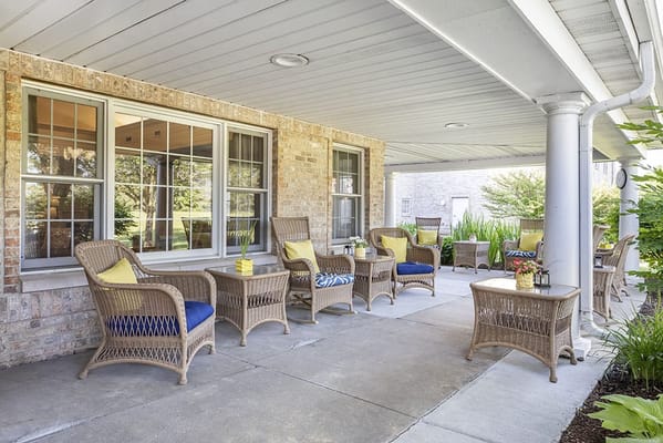 Outdoor seating area with wicker chairs and tables