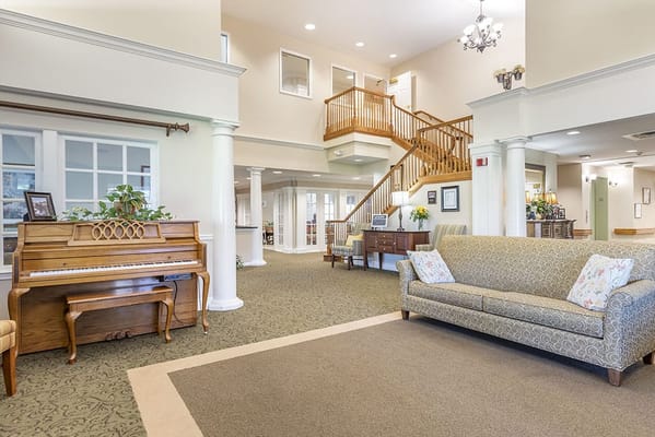 Interior view of a common area with a piano and sofa