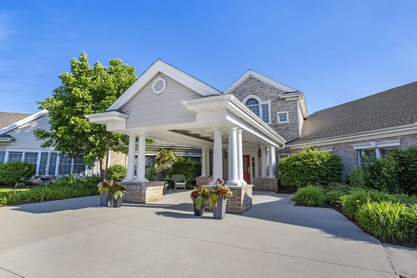 Entrance of a senior living facility with landscaped gardens