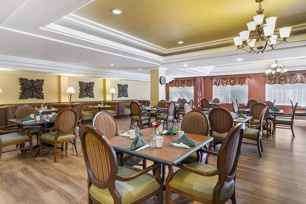 Dining area with tables and chairs set for a meal