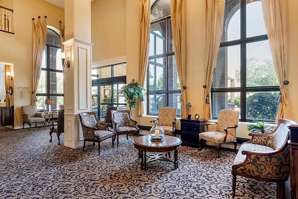 Bright and inviting lobby area with chairs and plants